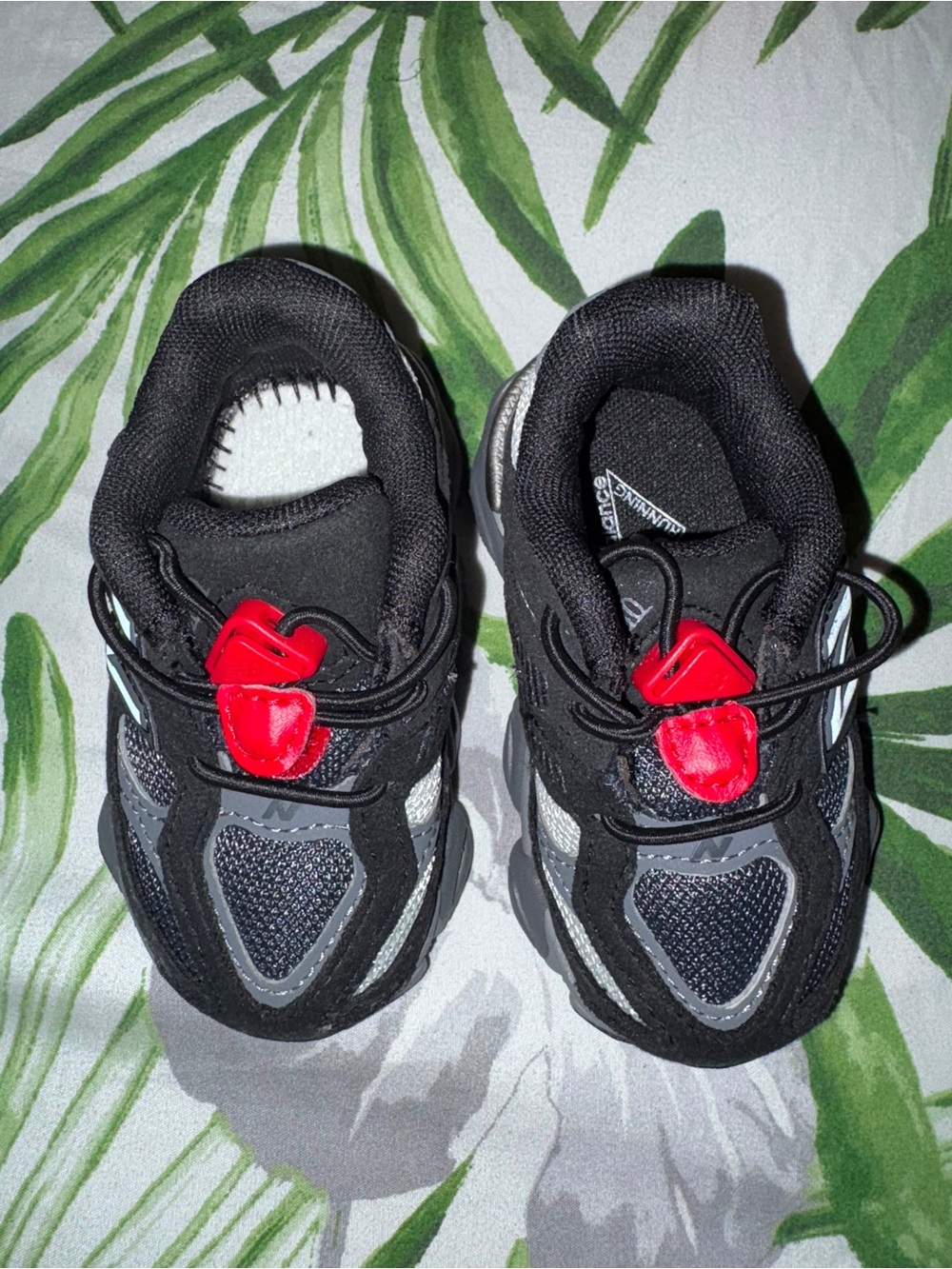 New Balance Kids Black and Red Sneakers with Reflective Accents
